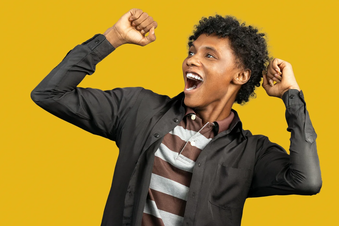 Excited person celebrating with raised fists, dreaming of a lottery win